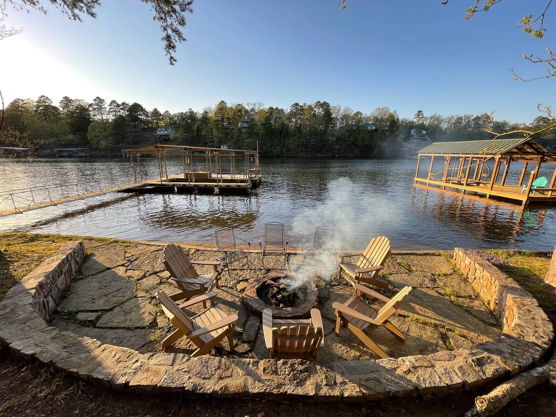 The stone fire pit at the water's edge on Lake Hamilton, with the dock beyond